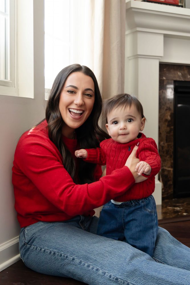 Cleveland in-home family photoshoot with mom, dad, and baby boy featuring natural light lifestyle photography, cozy candid moments, Valentine’s theme with red sweaters and chocolates, and their family dog
