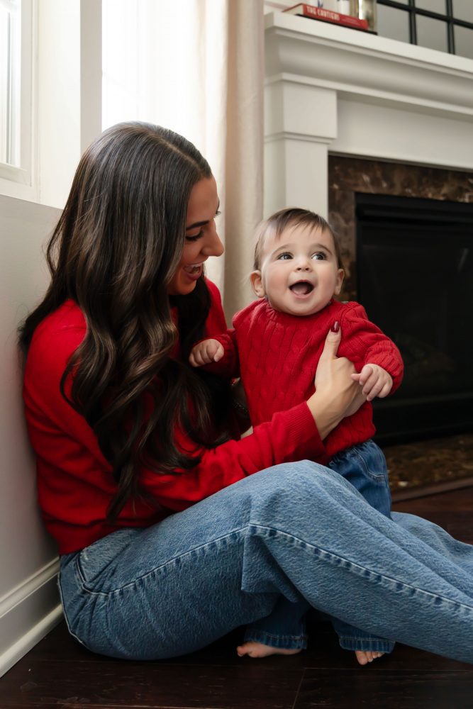 Cleveland in-home family photoshoot with mom, dad, and baby boy featuring natural light lifestyle photography, cozy candid moments, Valentine’s theme with red sweaters and chocolates, and their family dog