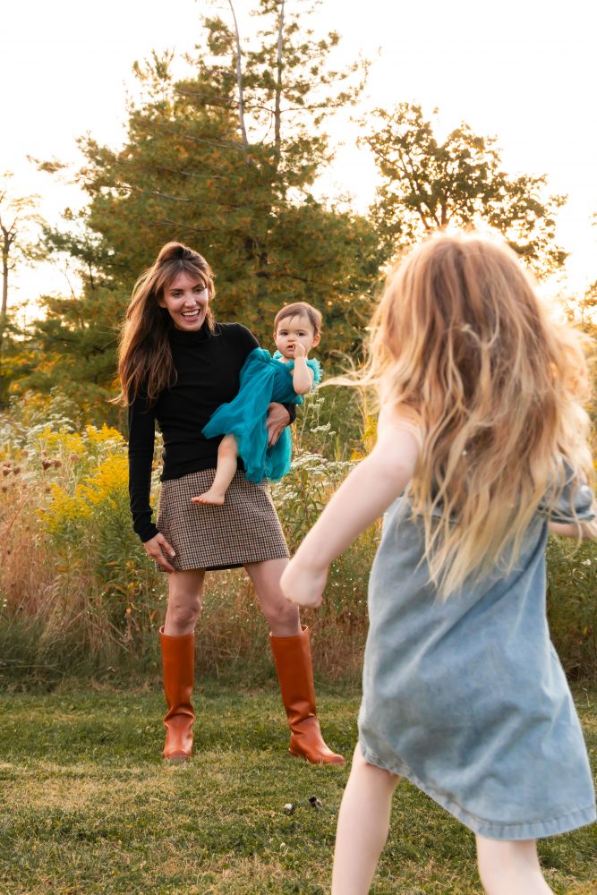 Sisters laughing with their mom in warm sunset light Cleveland Ohio family photography