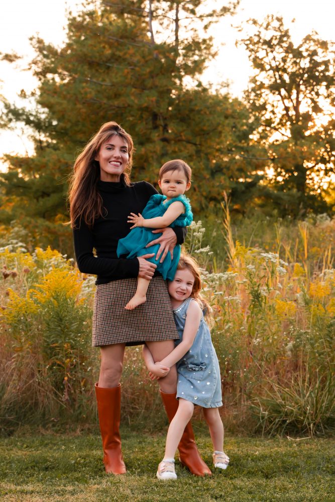 Sisters laughing with their mom in warm sunset light Cleveland Ohio family photography