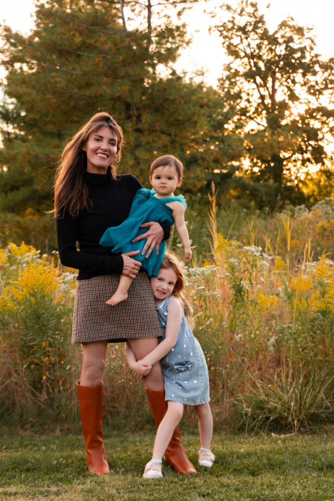 Sisters laughing with their mom in warm sunset light Cleveland Ohio family photography