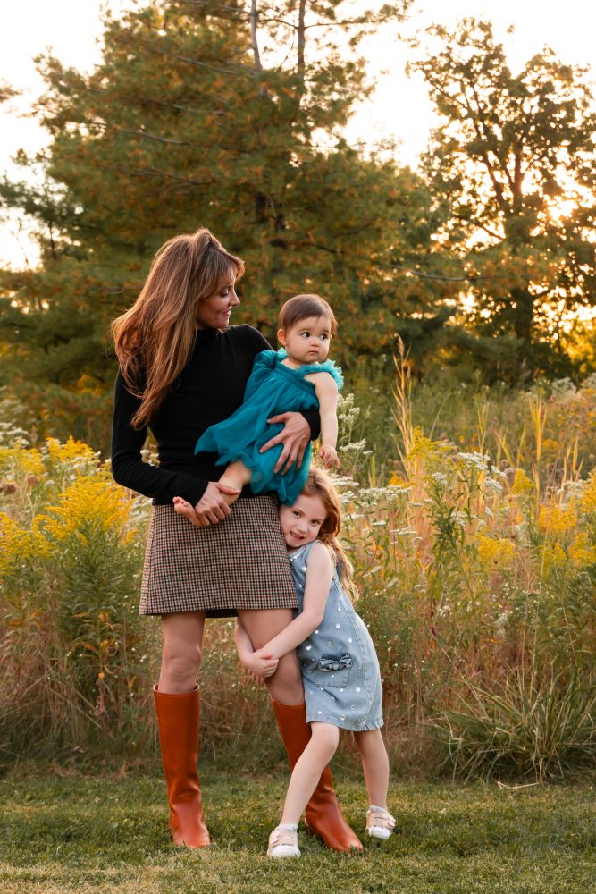Sisters laughing with their mom in warm sunset light Cleveland Ohio family photography
