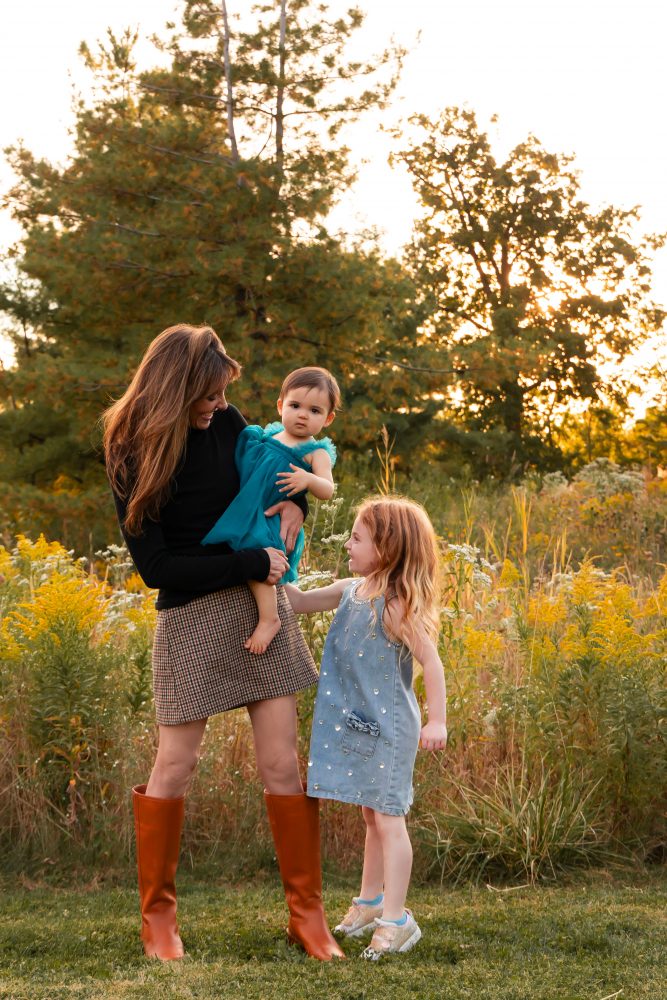 Sisters laughing with their mom in warm sunset light Cleveland Ohio family photography