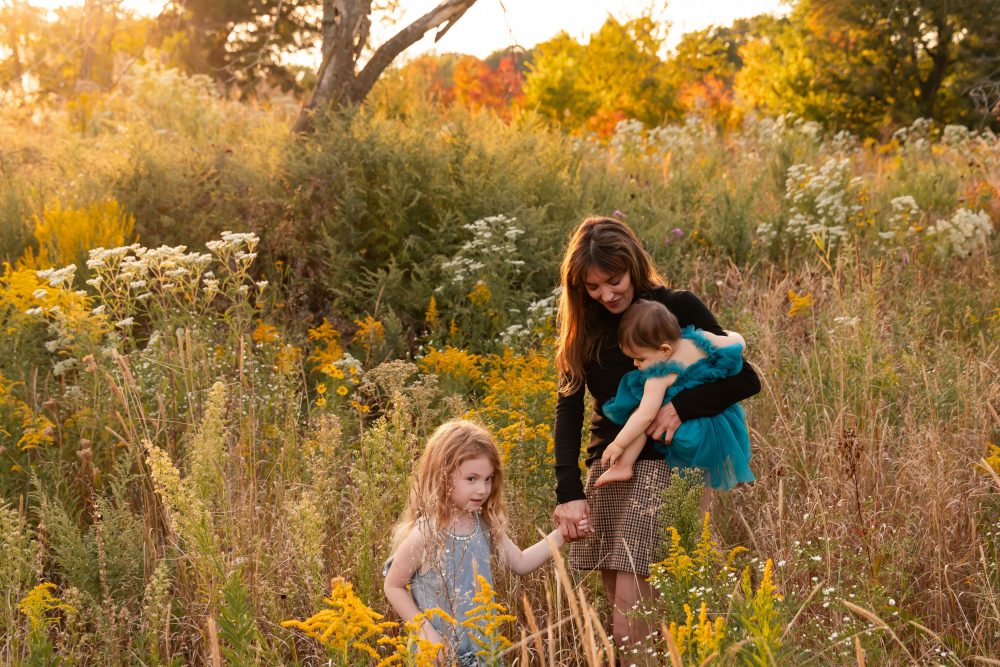 Sisters laughing with their mom in warm sunset light Cleveland Ohio family photography