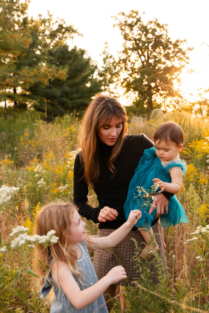 Sisters laughing with their mom in warm sunset light Cleveland Ohio family photography