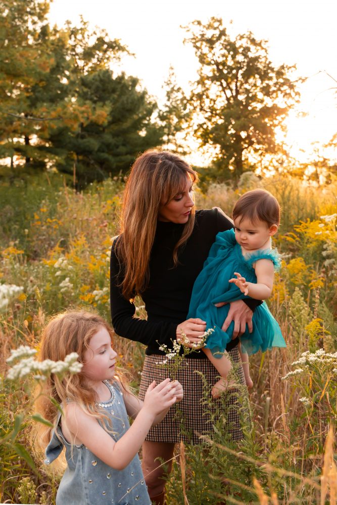 Sisters laughing with their mom in warm sunset light Cleveland Ohio family photography