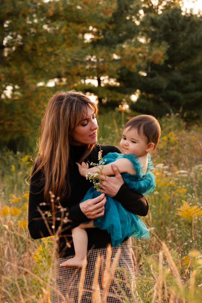 Sisters laughing with their mom in warm sunset light Cleveland Ohio family photography