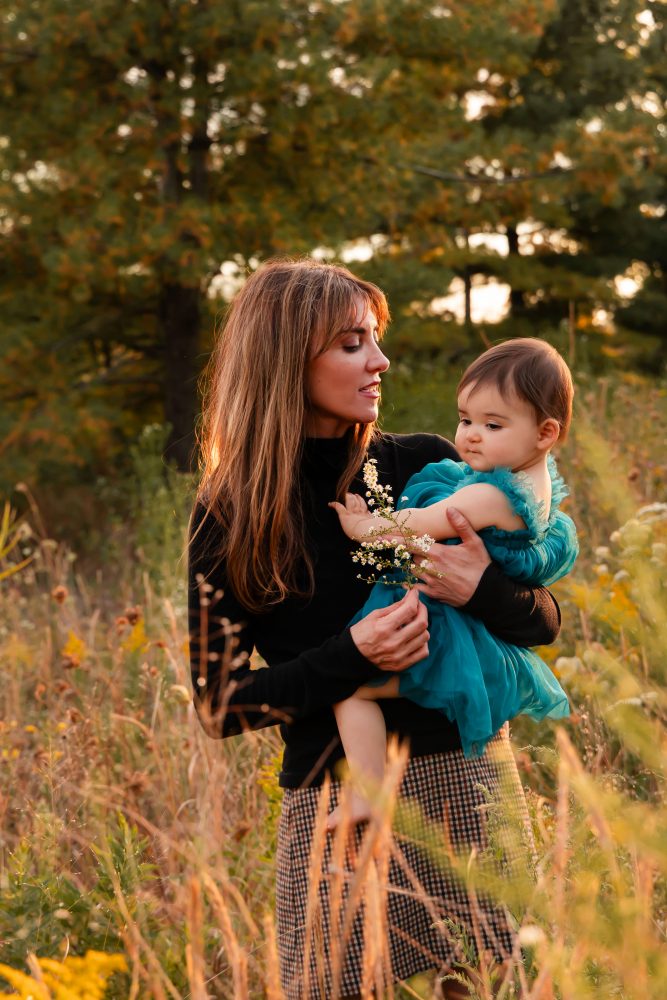 Sisters laughing with their mom in warm sunset light Cleveland Ohio family photography