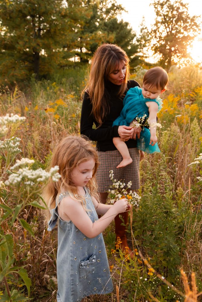 Sisters laughing with their mom in warm sunset light Cleveland Ohio family photography