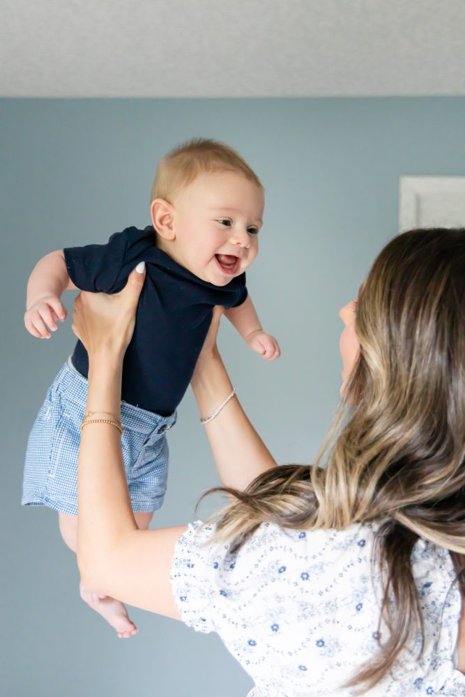 Lifestyle family portrait of parents with their newborn baby boy during in-home session in Cleveland Ohio.