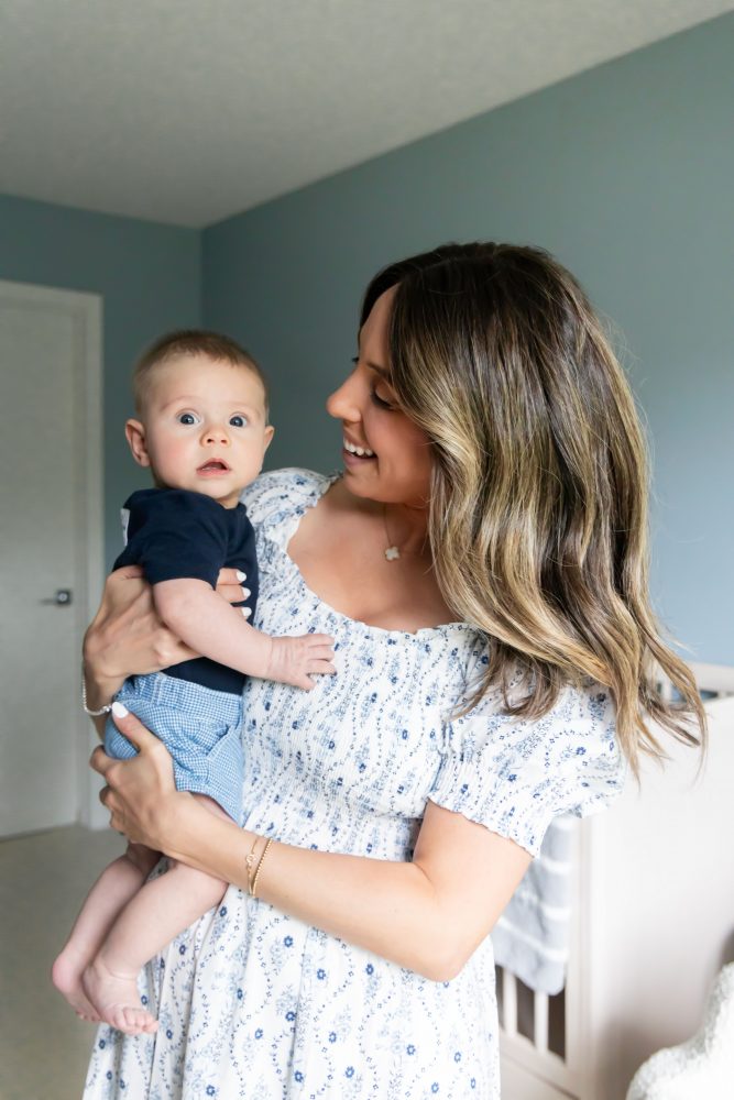 Lifestyle family portrait of parents with their newborn baby boy during in-home session in Cleveland Ohio.
