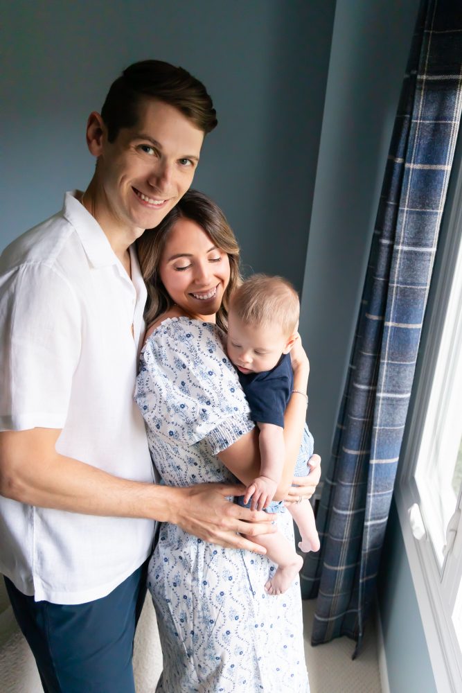 Lifestyle family portrait of parents with their newborn baby boy during in-home session in Cleveland Ohio.