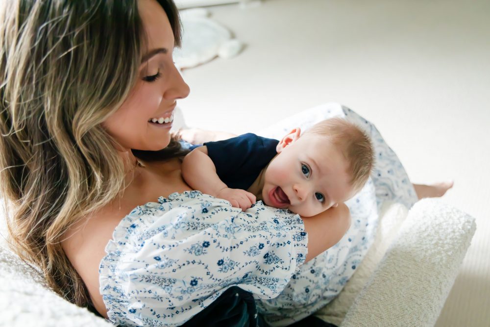 Lifestyle family portrait of parents with their newborn baby boy during in-home session in Cleveland Ohio.