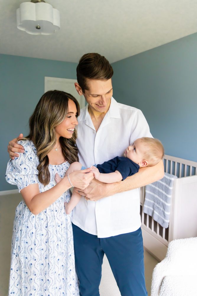 Lifestyle family portrait of parents with their newborn baby boy during in-home session in Cleveland Ohio.
