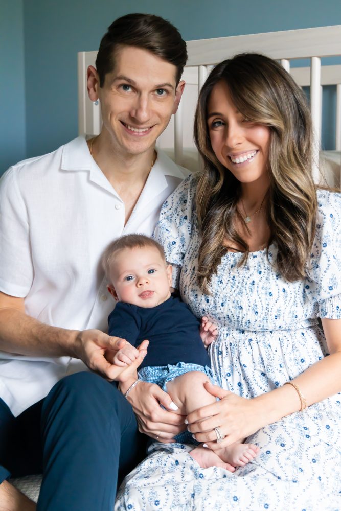 Lifestyle family portrait of parents with their newborn baby boy during in-home session in Cleveland Ohio.