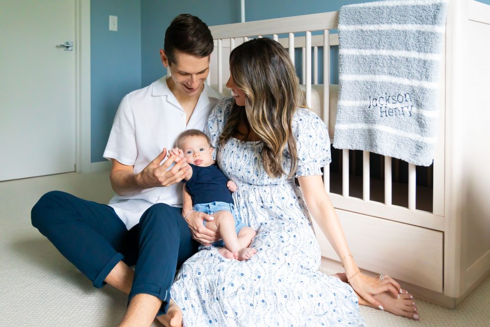 Lifestyle family portrait of parents with their newborn baby boy during in-home session in Cleveland Ohio.