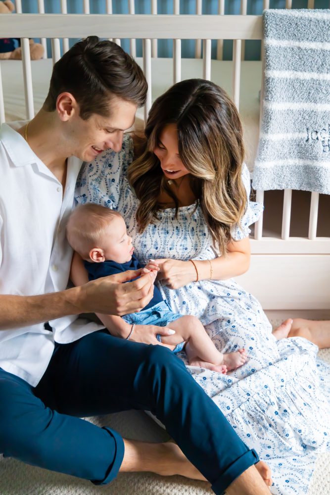 Lifestyle family portrait of parents with their newborn baby boy during in-home session in Cleveland Ohio.