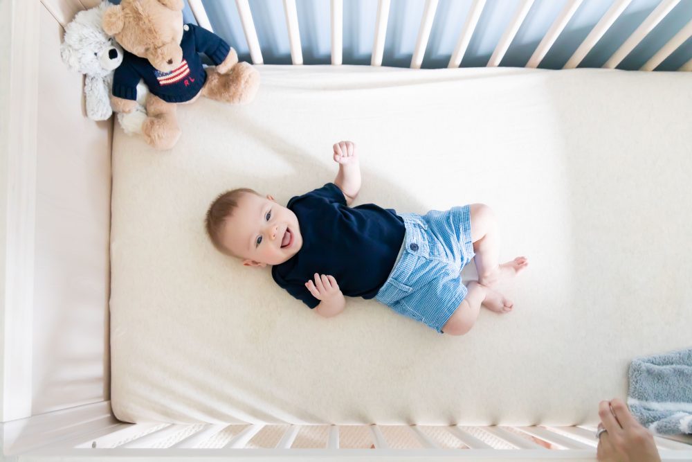 Lifestyle family portrait of parents with their newborn baby boy during in-home session in Cleveland Ohio.