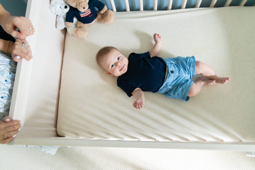Lifestyle family portrait of parents with their newborn baby boy during in-home session in Cleveland Ohio.