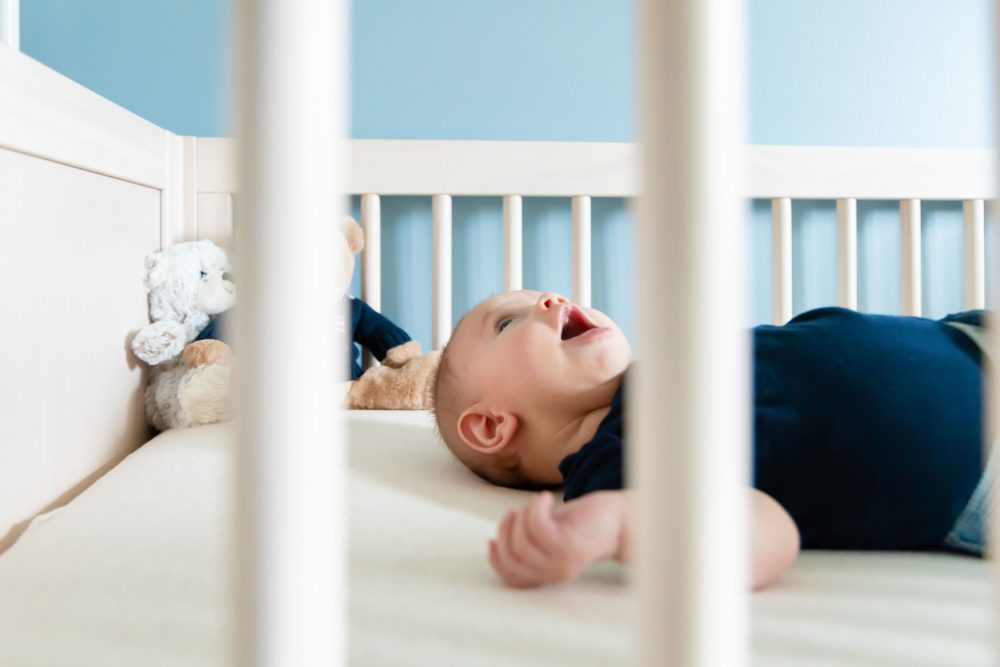 Lifestyle family portrait of parents with their newborn baby boy during in-home session in Cleveland Ohio.