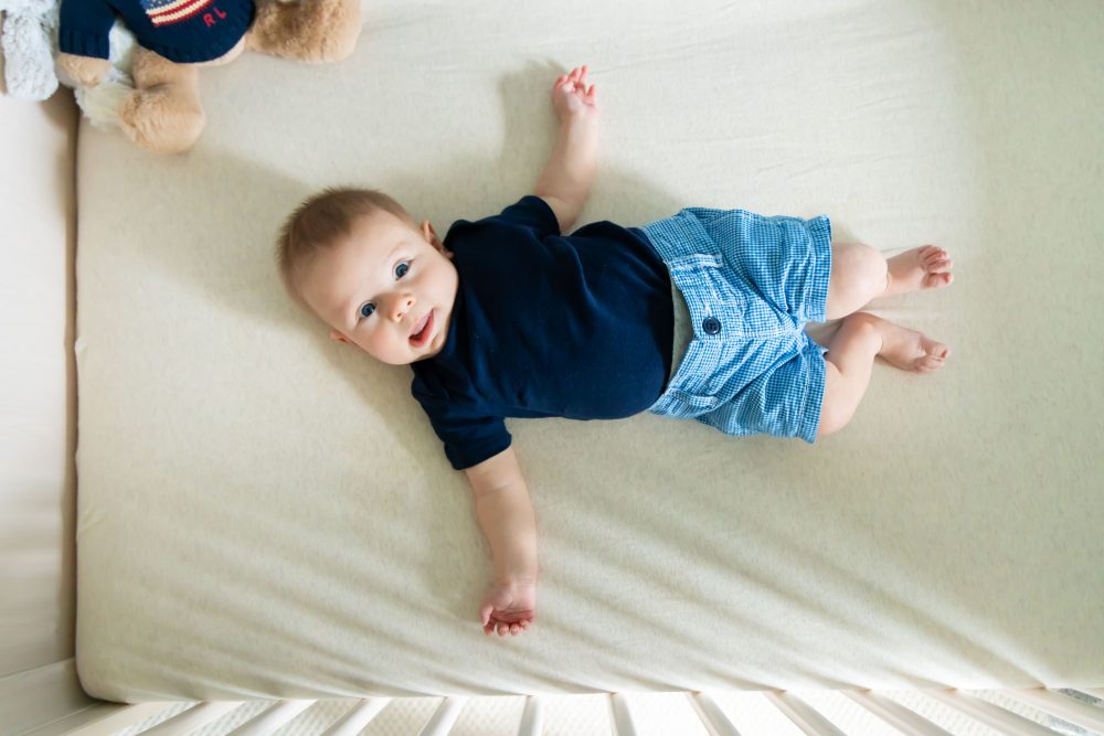 Lifestyle family portrait of parents with their newborn baby boy during in-home session in Cleveland Ohio.