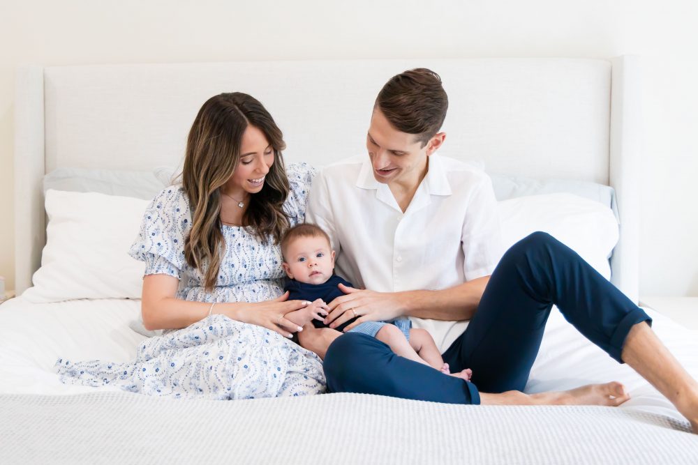 Lifestyle family portrait of parents with their newborn baby boy during in-home session in Cleveland Ohio.