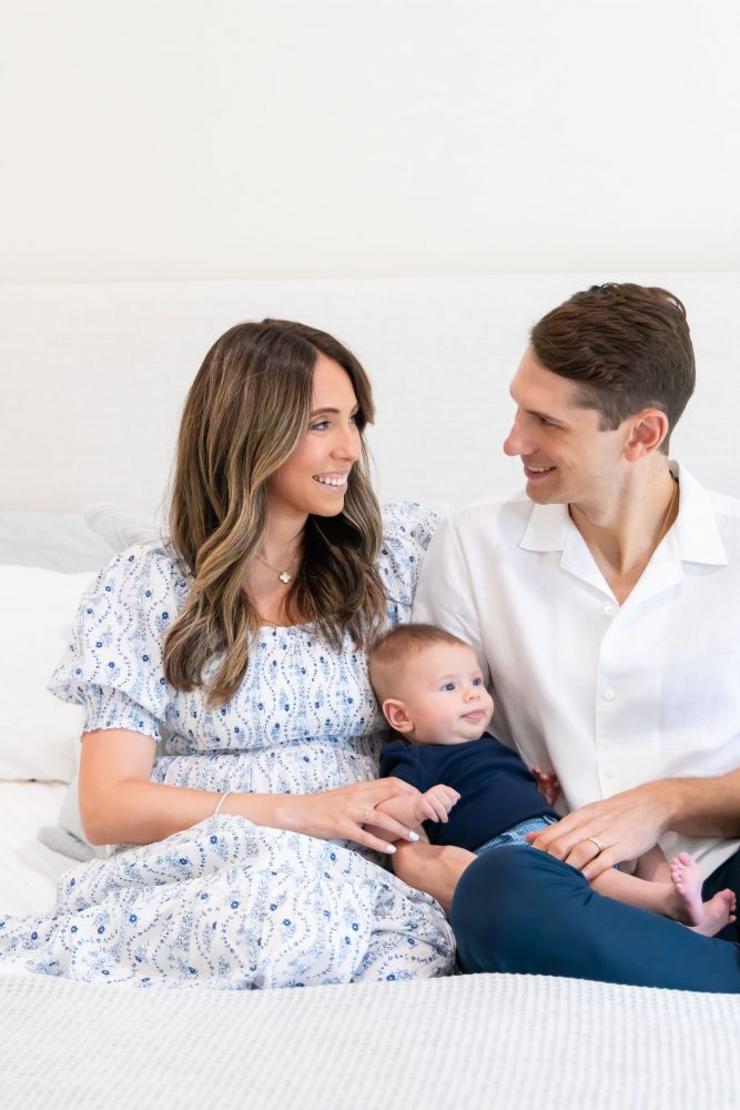 Lifestyle family portrait of parents with their newborn baby boy during in-home session in Cleveland Ohio.