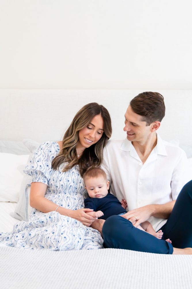 Lifestyle family portrait of parents with their newborn baby boy during in-home session in Cleveland Ohio.