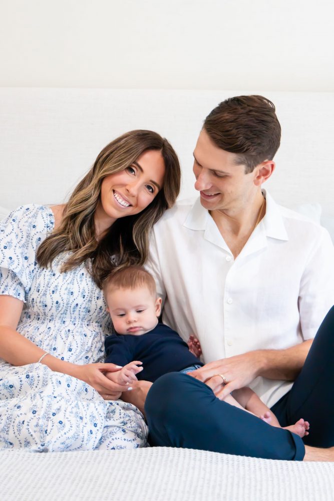 Lifestyle family portrait of parents with their newborn baby boy during in-home session in Cleveland Ohio.