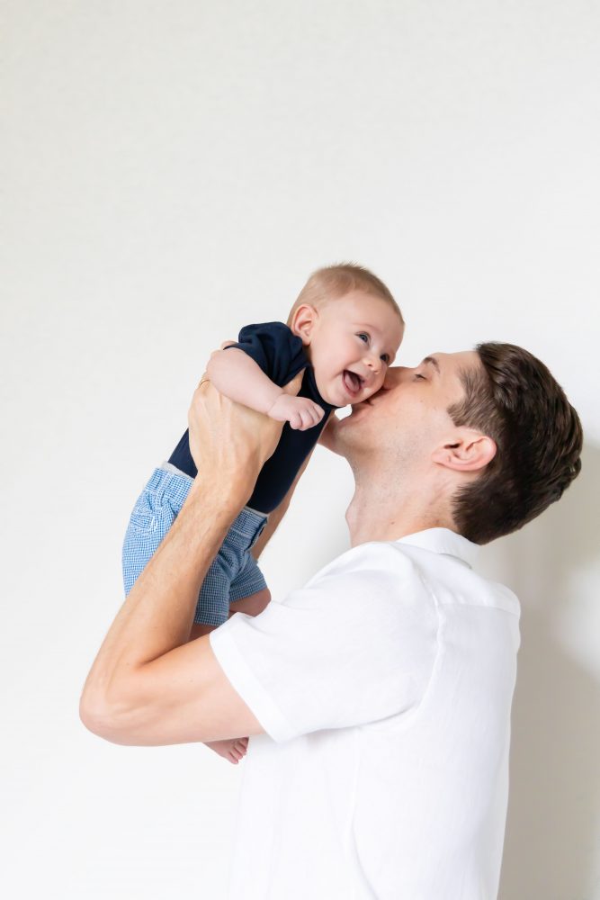 Lifestyle family portrait of parents with their newborn baby boy during in-home session in Cleveland Ohio.