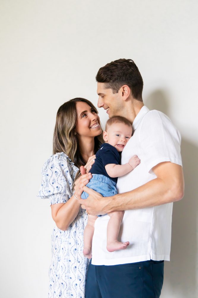 Lifestyle family portrait of parents with their newborn baby boy during in-home session in Cleveland Ohio.