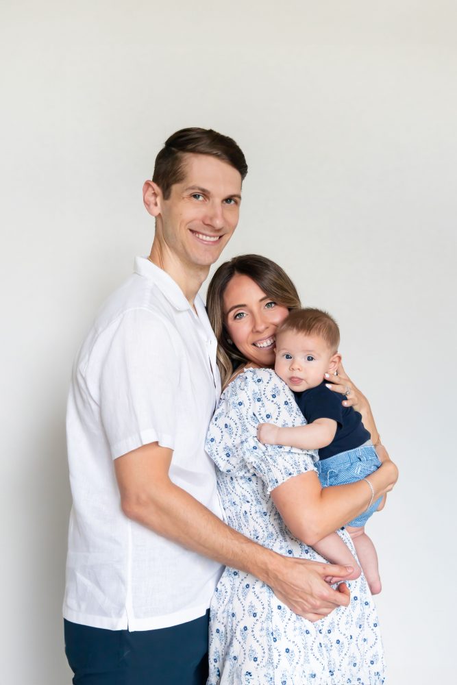 Lifestyle family portrait of parents with their newborn baby boy during in-home session in Cleveland Ohio.