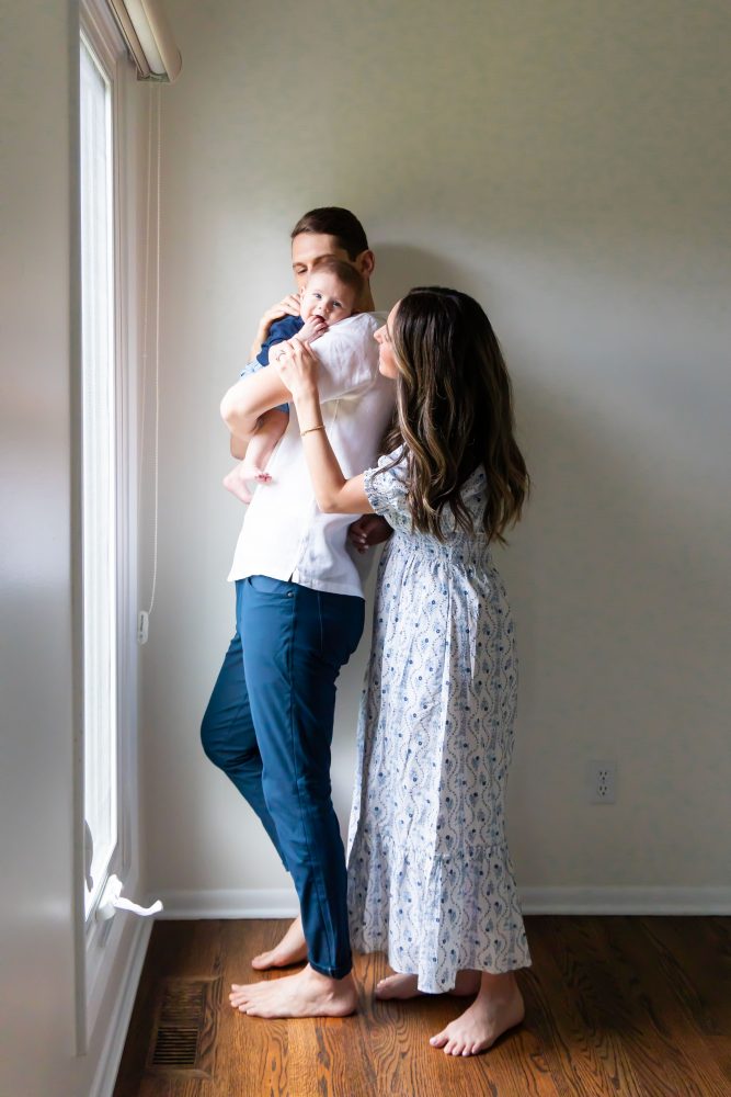 Lifestyle family portrait of parents with their newborn baby boy during in-home session in Cleveland Ohio.
