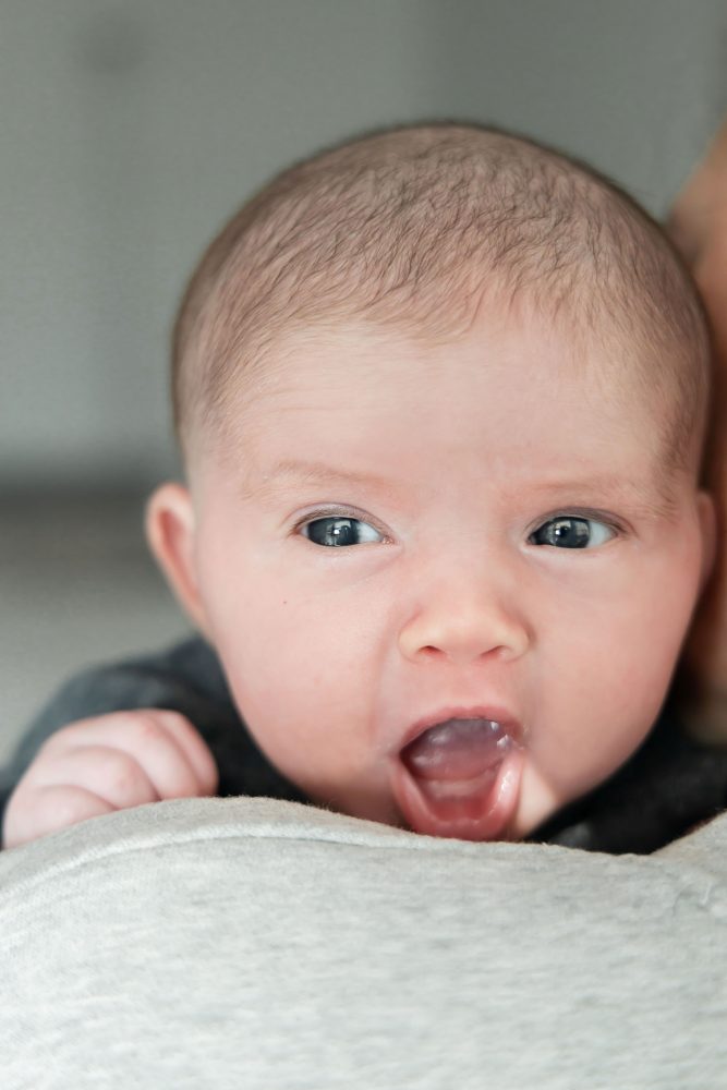 Cleveland newborn photography of baby in neutral outfit, natural light, simple baby-only session