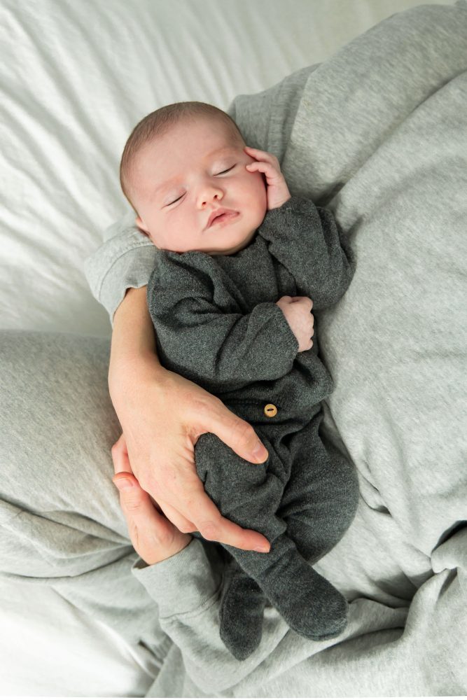 Cleveland newborn photography of baby in neutral outfit, natural light, simple baby-only session