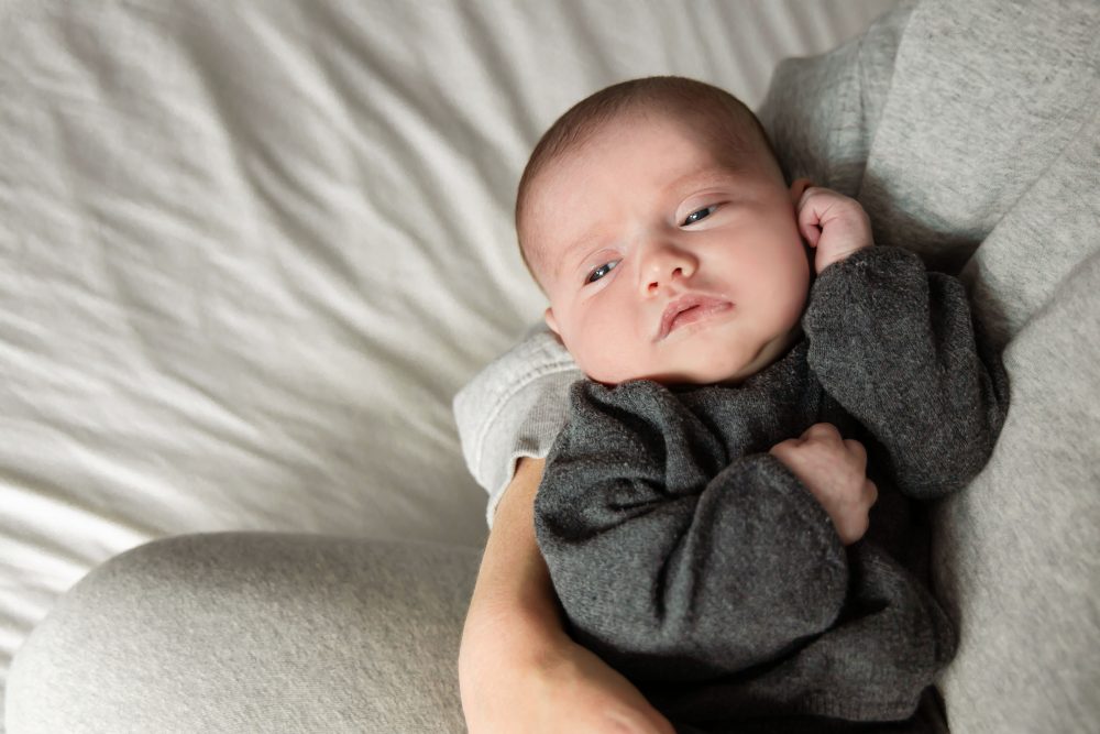 Cleveland newborn photography of baby in neutral outfit, natural light, simple baby-only session