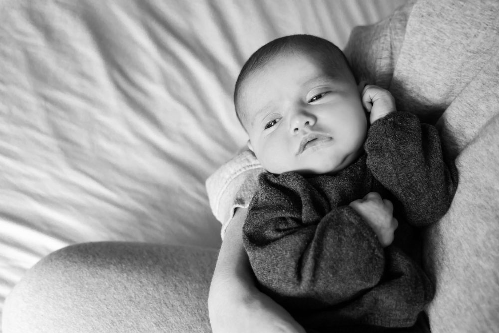 Cleveland newborn photography of baby in neutral outfit, natural light, simple baby-only session