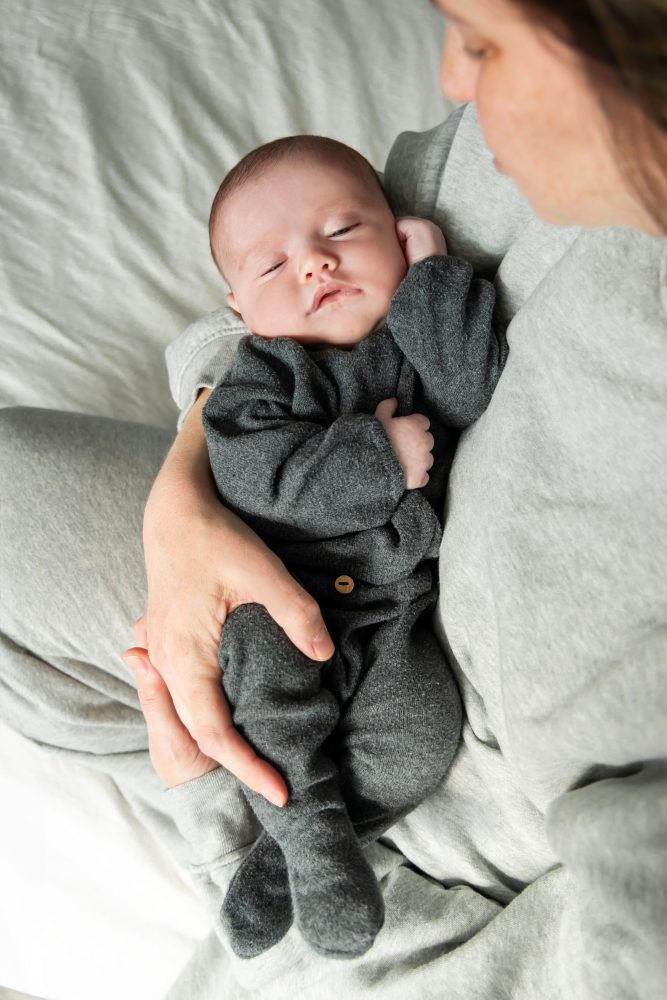 Cleveland newborn photography of baby in neutral outfit, natural light, simple baby-only session