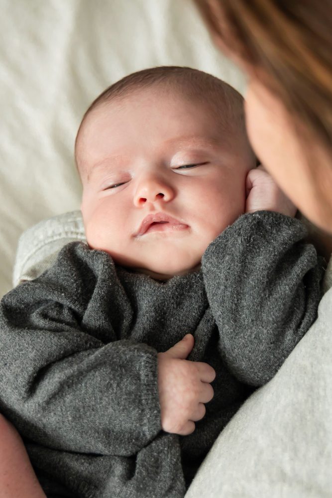 Lifestyle newborn photos of baby resting and stretching, minimal and natural Cleveland photographer