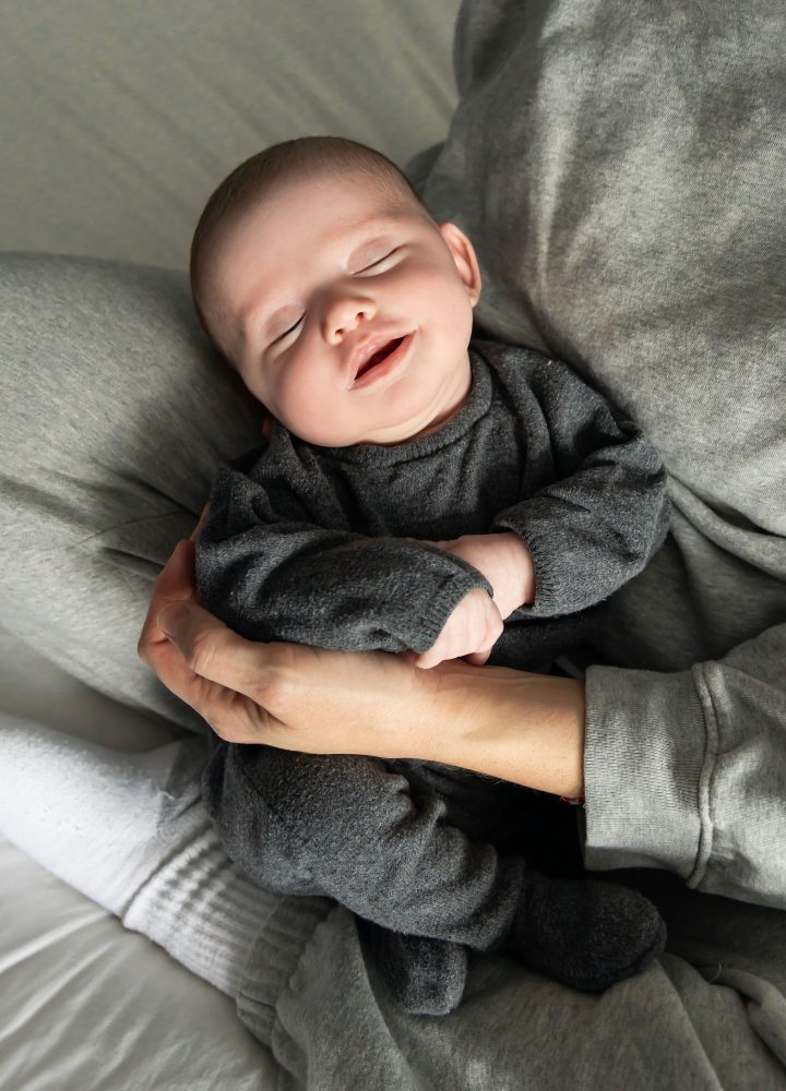 Lifestyle newborn photos of baby resting and stretching, minimal and natural Cleveland photographer