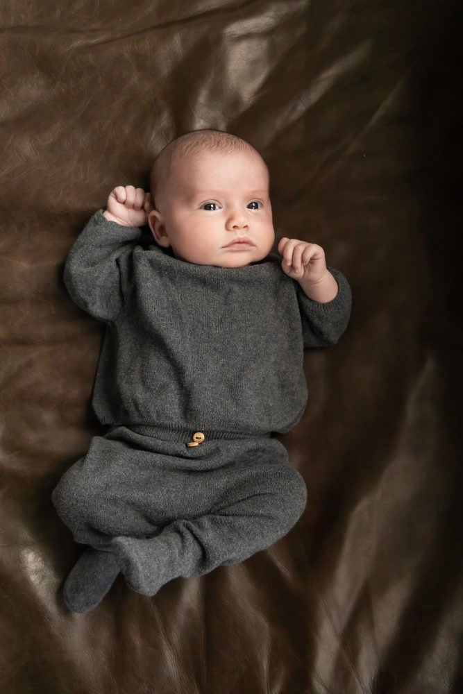 Cleveland newborn photography of baby in neutral outfit, natural light, simple baby-only session