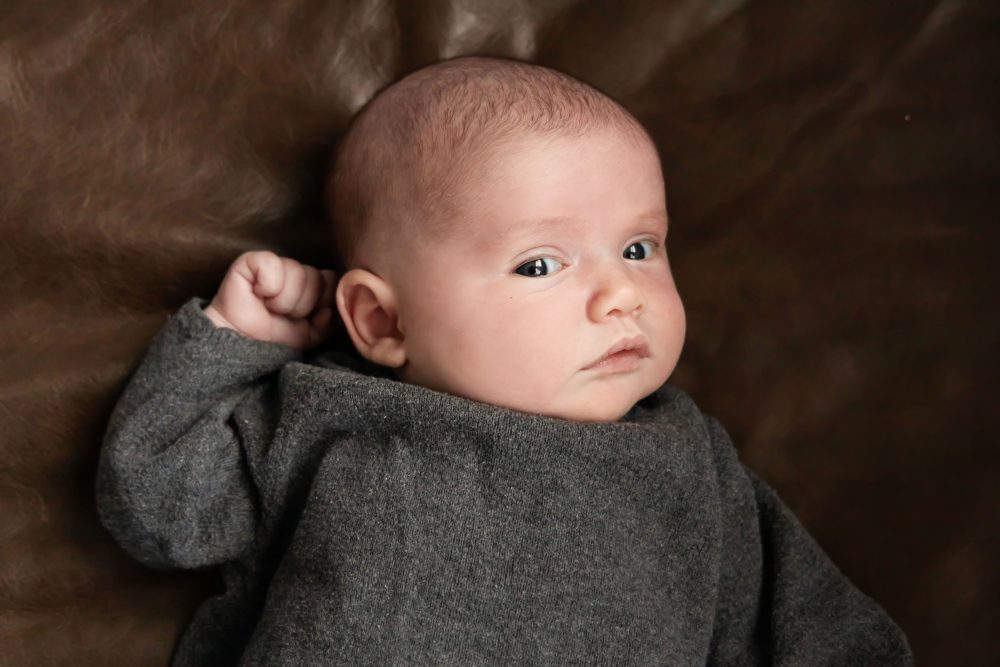 Cleveland newborn photography of baby in neutral outfit, natural light, simple baby-only session