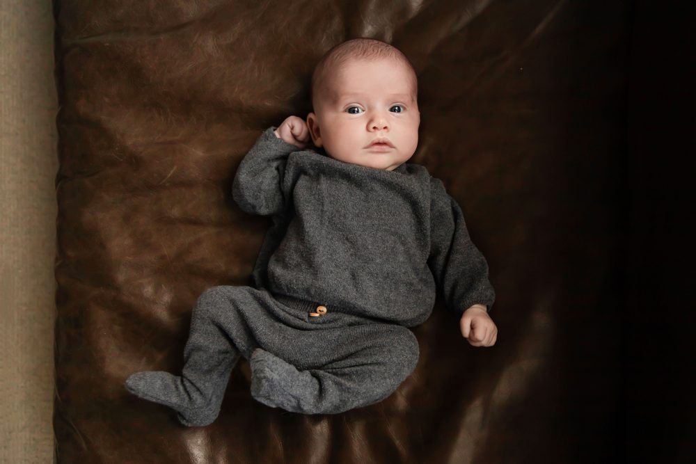 Cleveland newborn photography of baby in neutral outfit, natural light, simple baby-only session