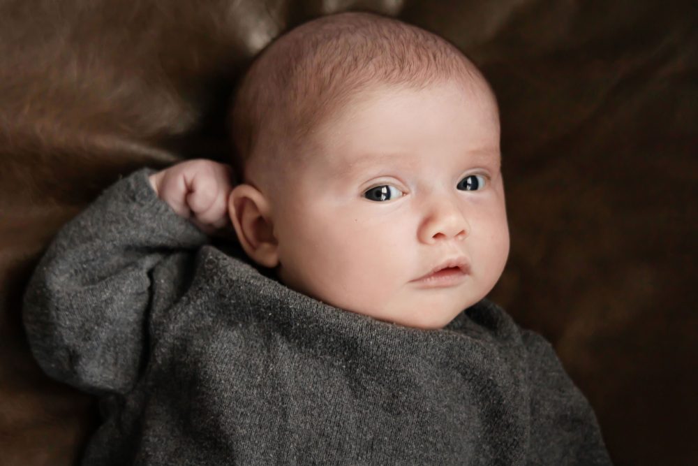 Cleveland newborn photography of baby in neutral outfit, natural light, simple baby-only session
