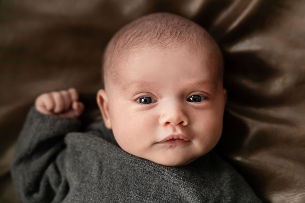 Cleveland newborn photography of baby in neutral outfit, natural light, simple baby-only session