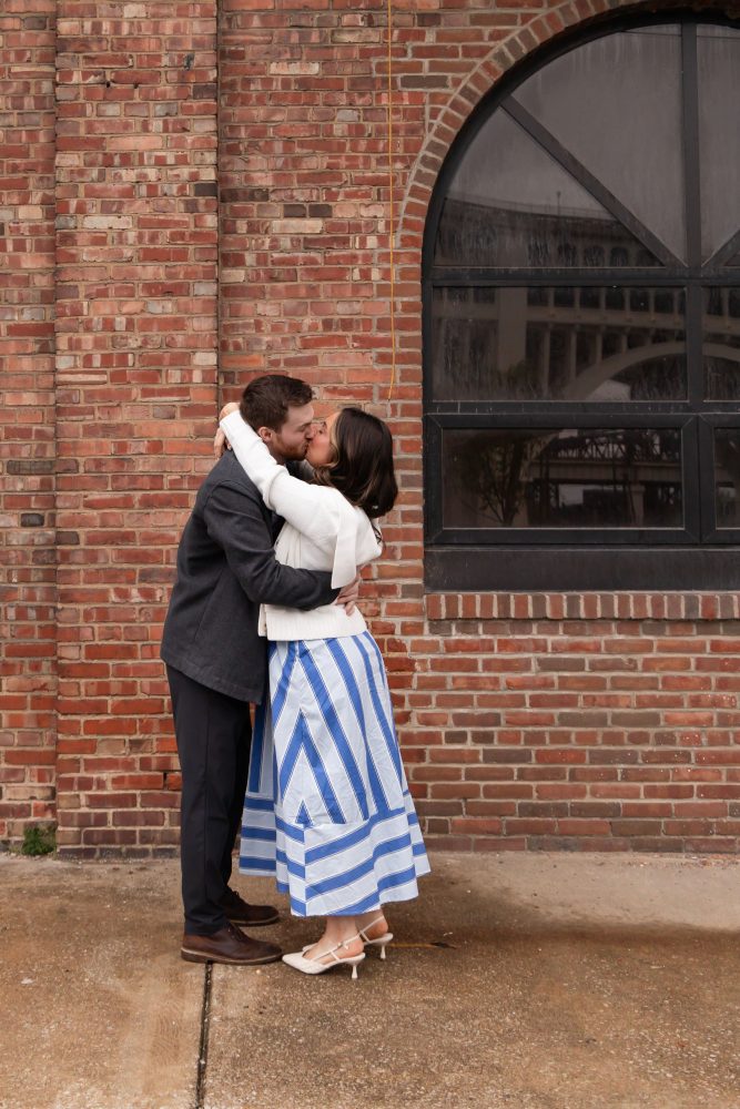 Newly engaged couple embracing after romantic proposal in downtown Cleveland, Ohio