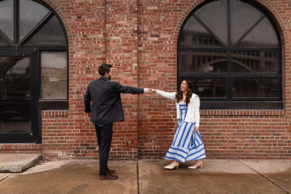 Newly engaged couple embracing after romantic proposal in downtown Cleveland, Ohio