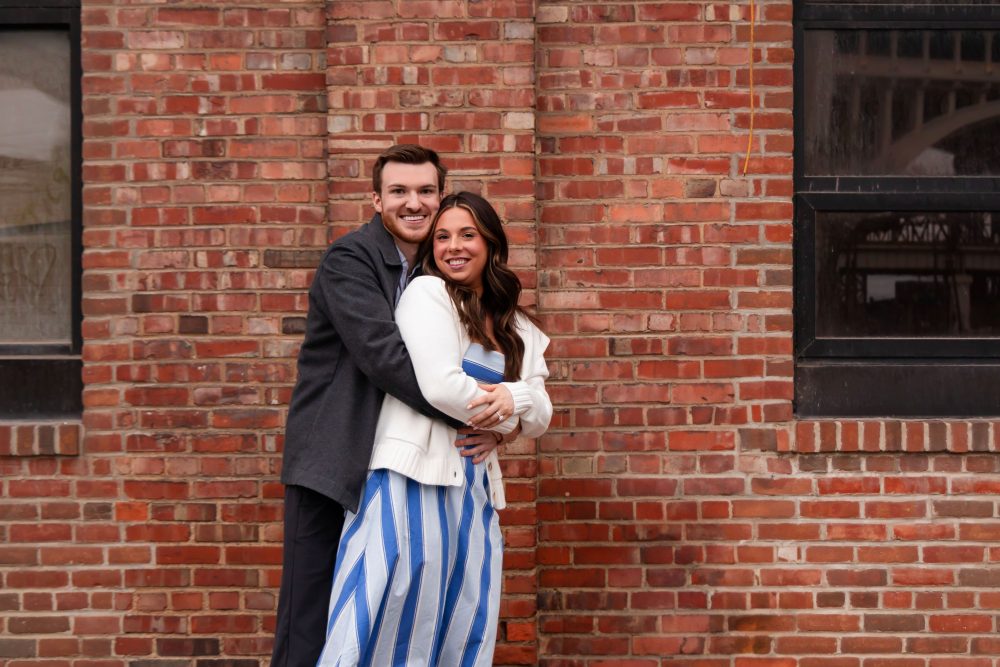 Newly engaged couple embracing after romantic proposal in downtown Cleveland, Ohio
