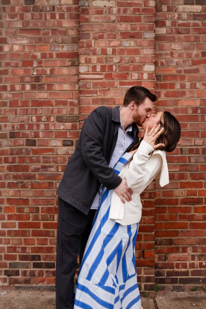 Newly engaged couple embracing after romantic proposal in downtown Cleveland, Ohio