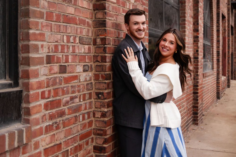 Newly engaged couple embracing after romantic proposal in downtown Cleveland, Ohio